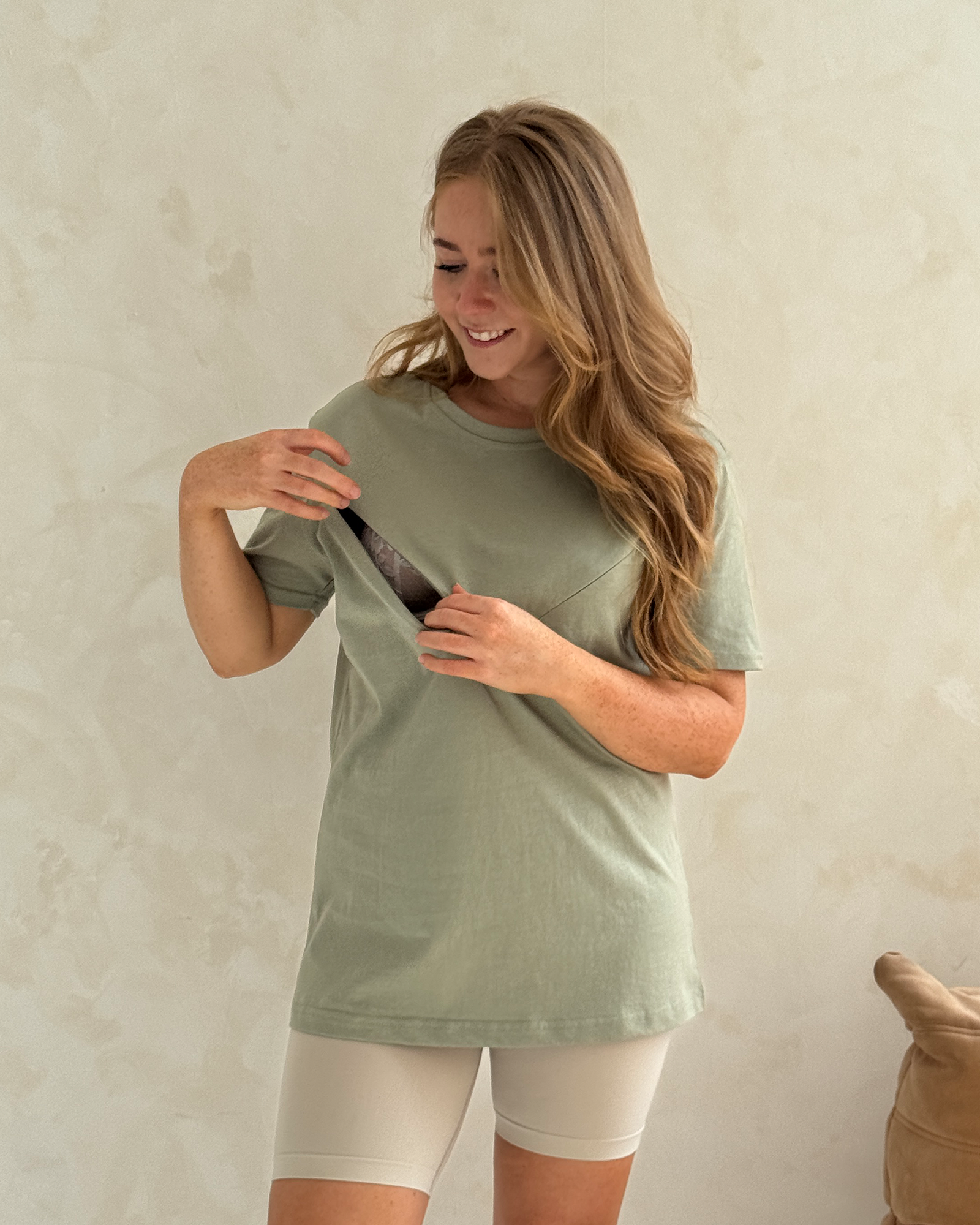 Pretty Mama olive breastfeeding t-shirt with diagonal zip open, front view